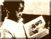 photo of a young African American boy reading a book