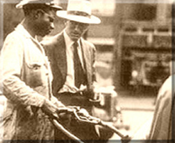 old photograph of an African American man workong for a white man
